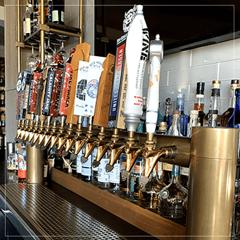 Powder Coated Beer Tower Taps With A Wine Rack In The Background