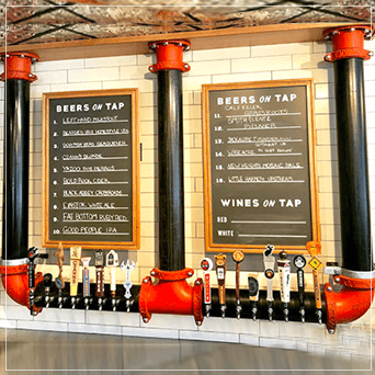 Hanging Draft Beer Tower In Front Of A Beer Menu
