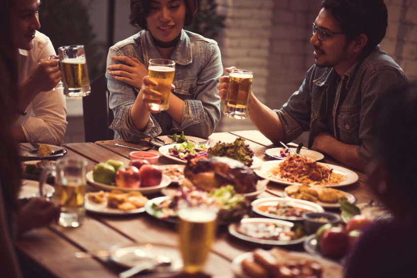 A happy group of family or friends enjoying the best beer for Thanksgiving.